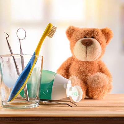 Teddy bear with toothbrush and toothpaste