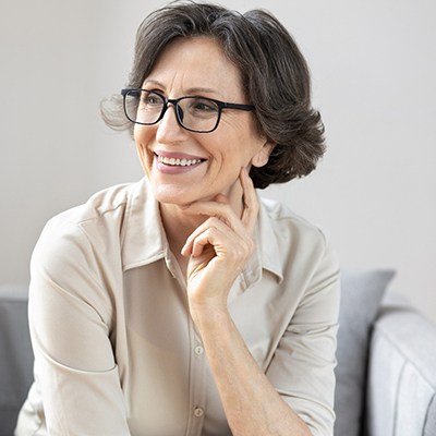 a person with glasses on smiling