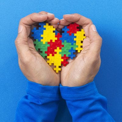 Child holding a heart made of blocks