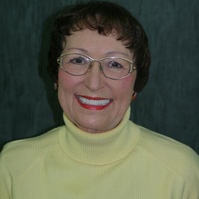 Woman with dental implants San Marcos sitting and smiling