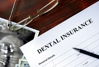 dental insurance form with a pen