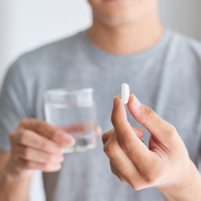 Man taking an oral conscious sedation dentistry pill