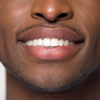 man smiling after getting veneers in San Marcos