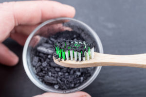 activated charcoal on wooden toothbrush
