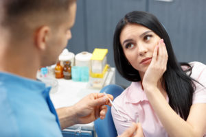 woman holding jaw from toothache