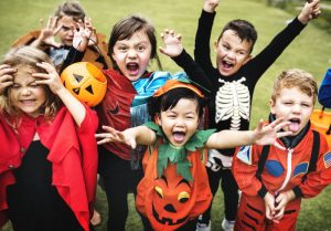 children dressed in Halloween costumes