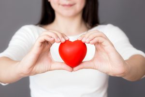 woman holding red love heart