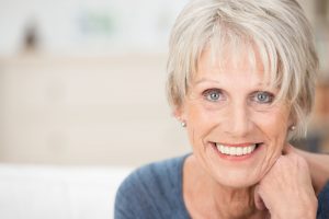 Older woman with healthy smile at dentist.