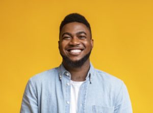 man smiling after getting cosmetic dentistry treatments 