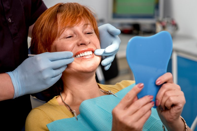 woman smiling after dental implant surgery