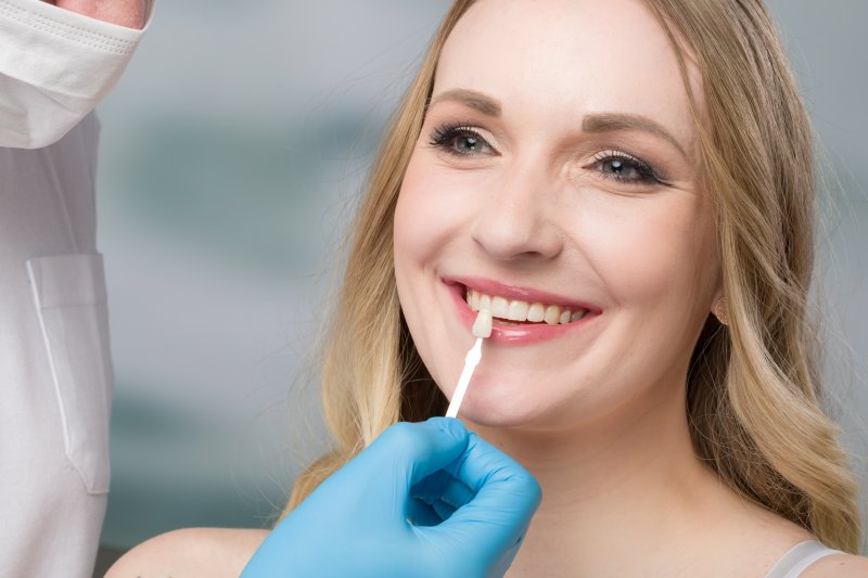 woman getting a veneer replacement in San Marcos