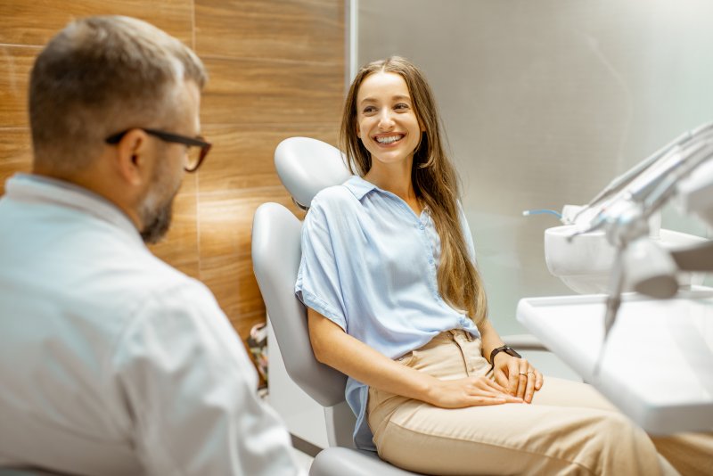 woman speaking to dentist about getting a smile makeover in San Marcos