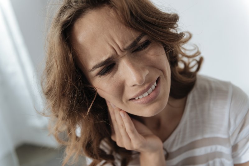 A woman feeling the connection between major depression and oral health in San Marcos