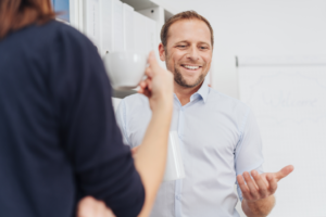 a person smiling and gesturing during a conversation 