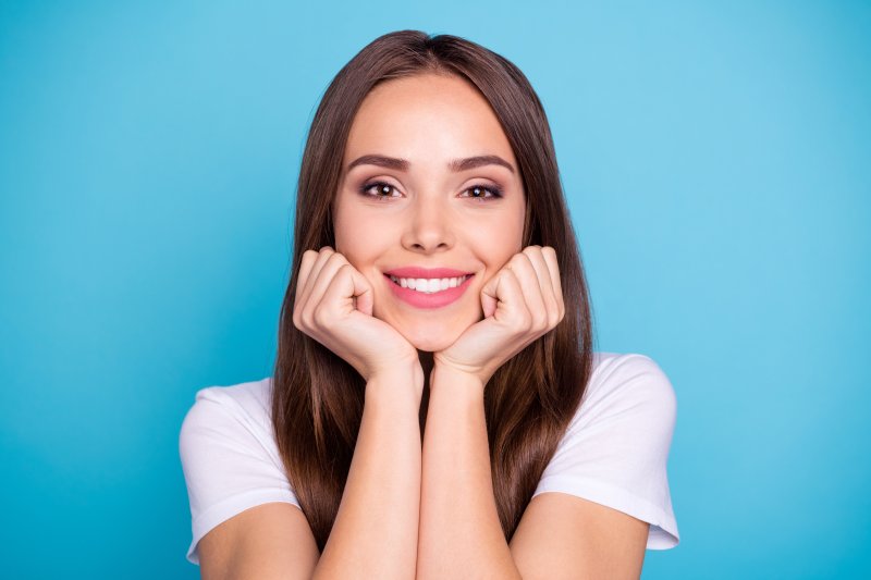 A woman smiling after her teeth whitening treatment