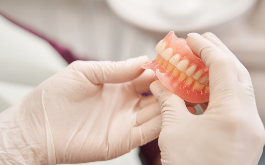 Dentist holding dentures