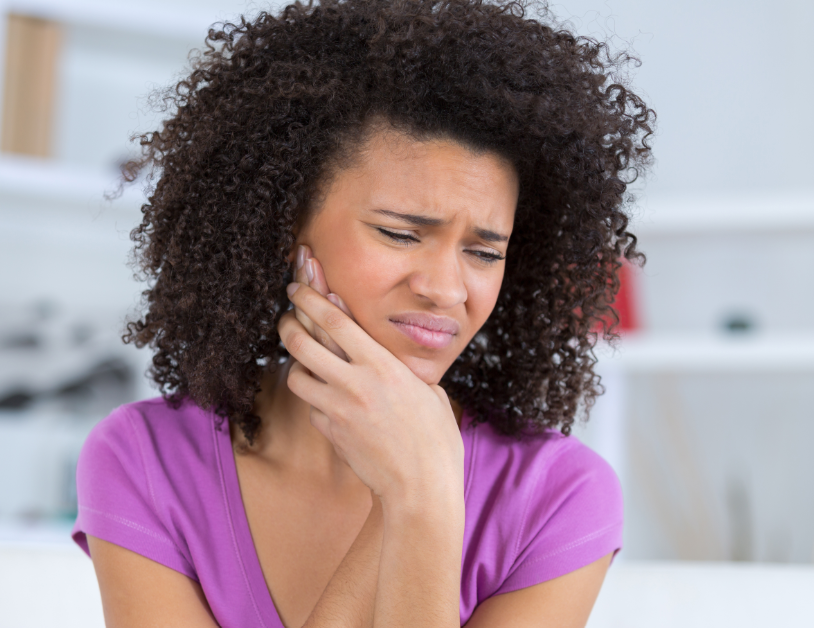 Woman holding jaw in pain
